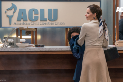 Felicity Jones in front of ACLU sign