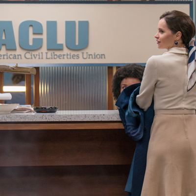 Felicity Jones in front of ACLU sign