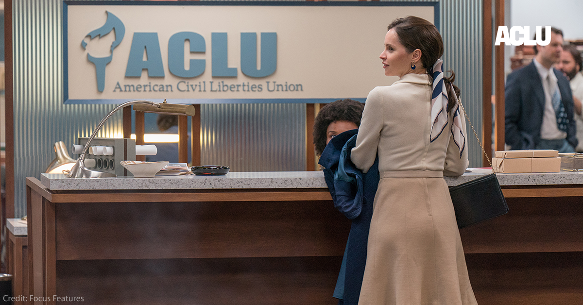 Felicity Jones in front of ACLU sign