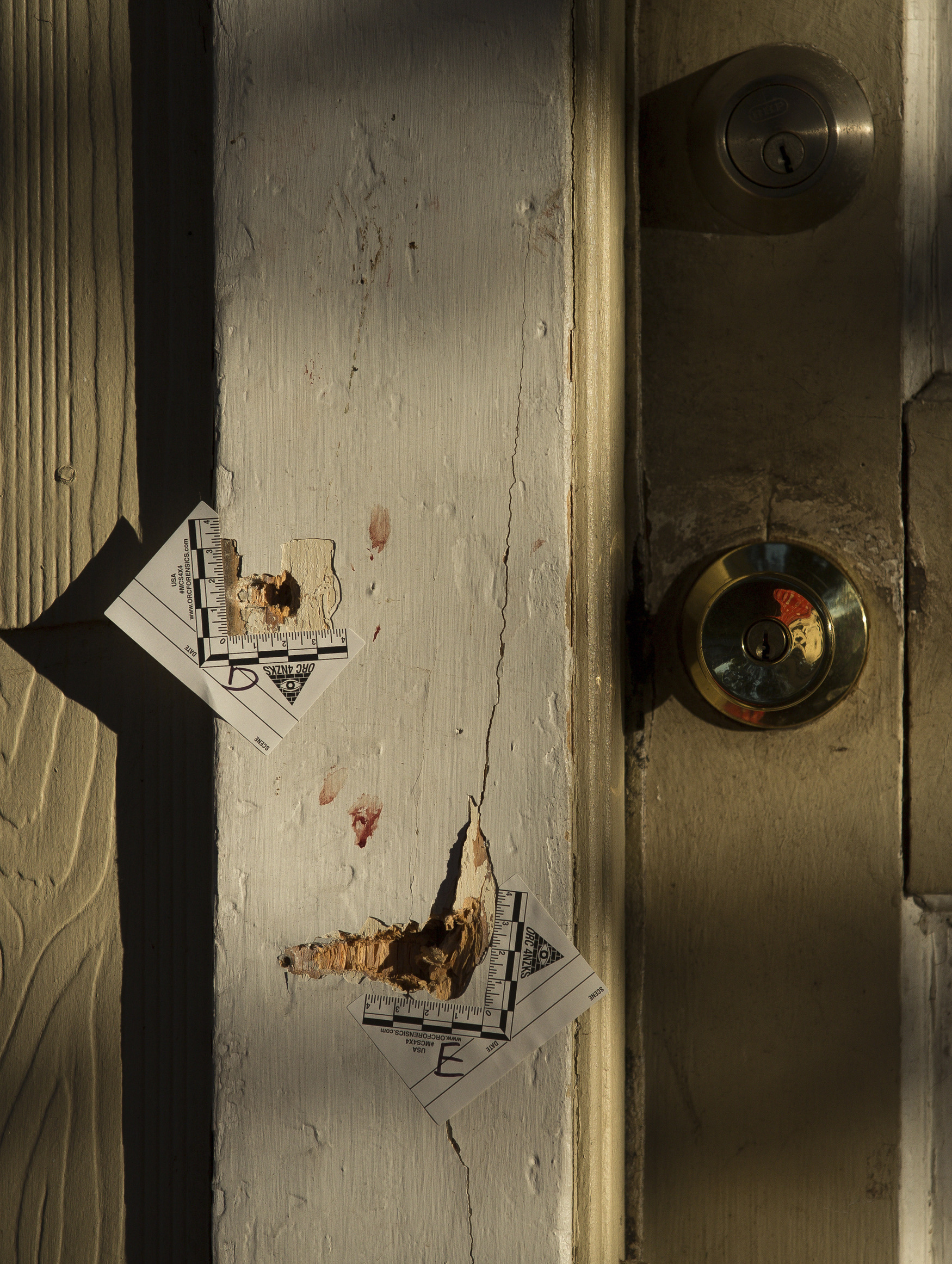 A door frame with bullet hole marks