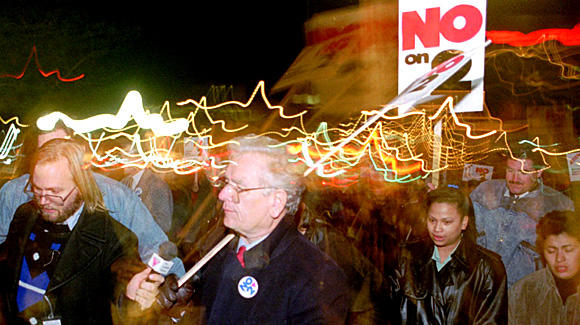 Former Colorado Governor Roy Romer and demonstrators