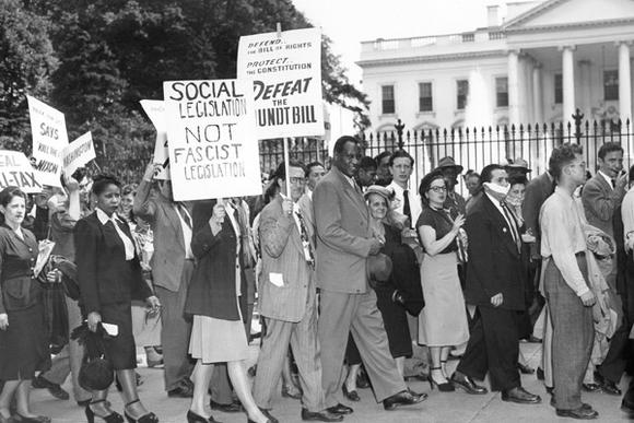 Paul Robeson leads a group of picketers carrying signs