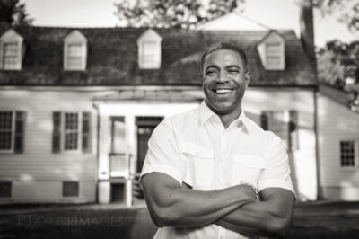 African American man in front of a house