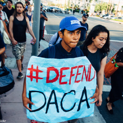 Boy holding "#Defend DACA" sign