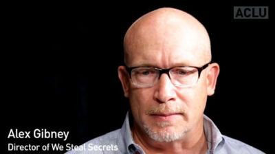 A man seen from the neck up with glasses.