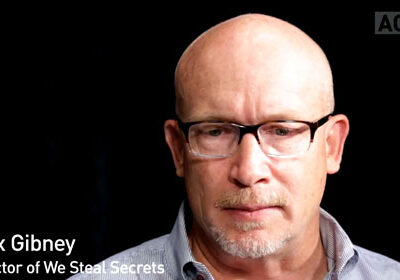 A man seen from the neck up with glasses.