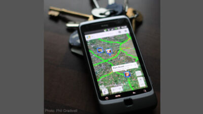 Image of a cell-phone displaying location information on a map.