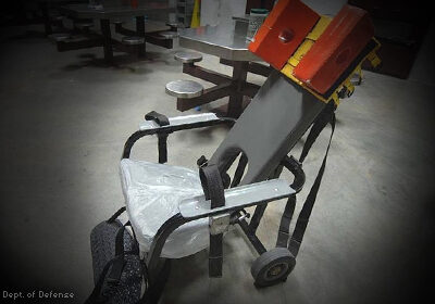 An empty prison restraining chair