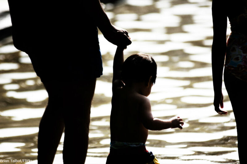 Parent holding hands with her child