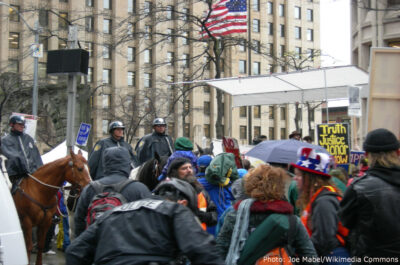 Seattle police on horseback watch protesters.