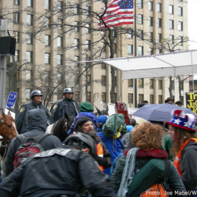 Seattle police on horseback watch protesters.