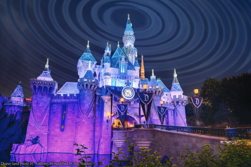 Disneyland castle at night with radio waves in sky above it