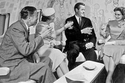 Four people enjoying vintage airline lounge