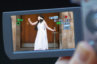 Image of Lady Justice on camcorder screen