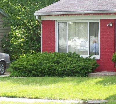 Red house with a green lawn