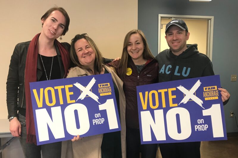 From left: Lillian Lennon (Transgender Community Organizer, ϰſ of Alaska); Liz Welch (ϰſ); Kati Ward (Fair Anchorage Campaign Manager); Joshua Decker (Executive Director, ϰſ of Alaska). All holding "Vote no on prop 1 signs."