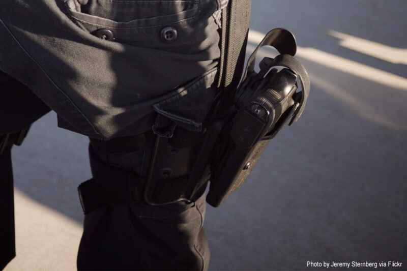 Closeup of gun on police officer's hip