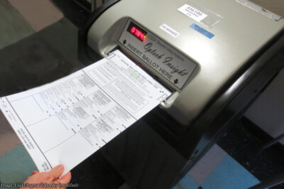 Ballot being fed into voting machine