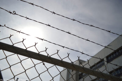 A barbed wire fence outside a prison