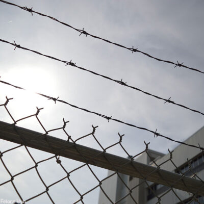 A barbed wire fence outside a prison