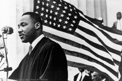 MLK in front of American flag