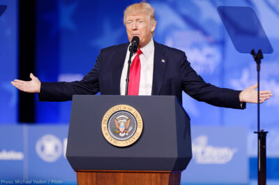 President Trump at Podium With Arms Spread