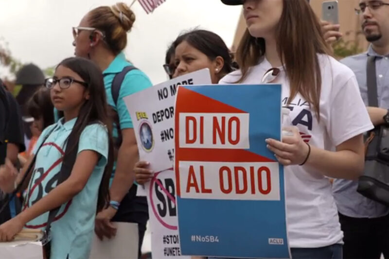 Protesters holding "No SB4" signs