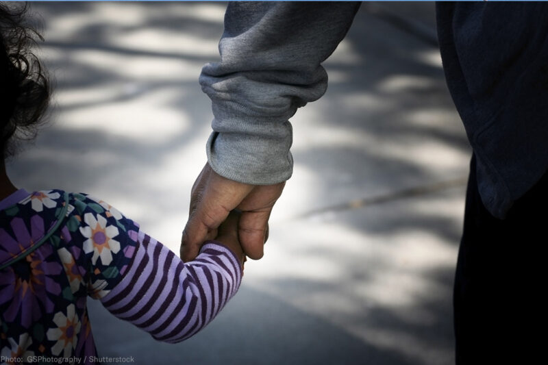 Father holding daughter's hand