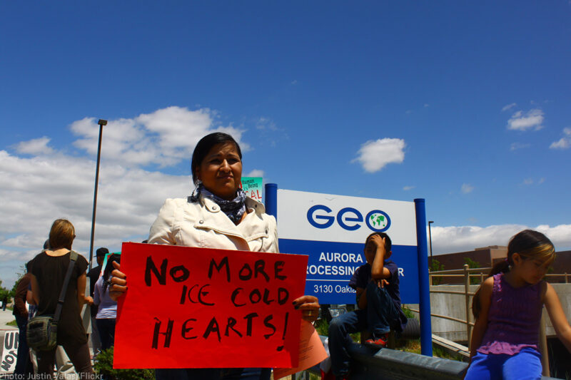 Protester in front of GeoGroup offices