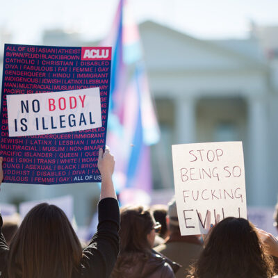 White Protest with poster: No Body is Illegal