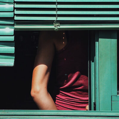 Woman Behind Shutters