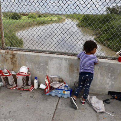 Girl standing on a bridge at the border