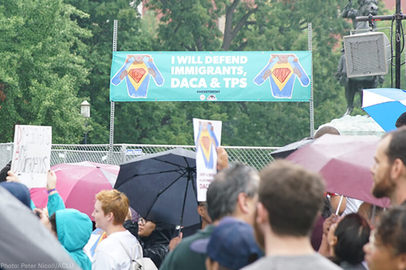 "I will defend immigrants, DACA, and TPS" sign at a rally