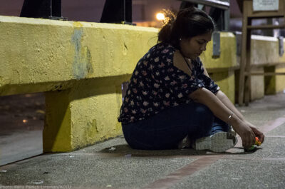 Woman sitting on the road