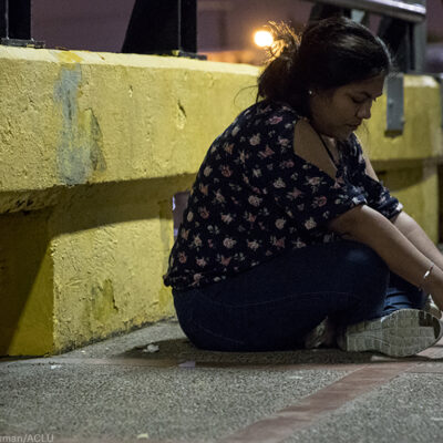 Woman sitting on the road