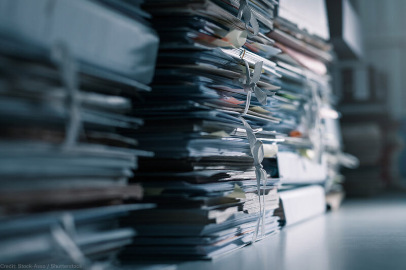 Stacks of files in a dark office