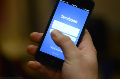 Smart phone in hand with Facebook app