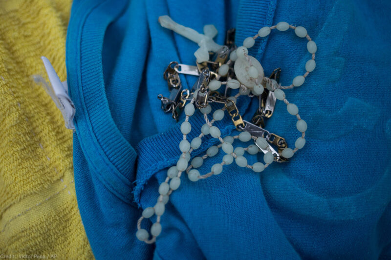 A rosary on a blue shirt