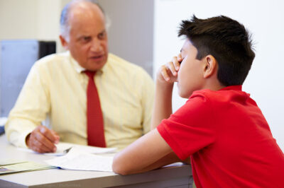 Distressed student sitting with a counselor