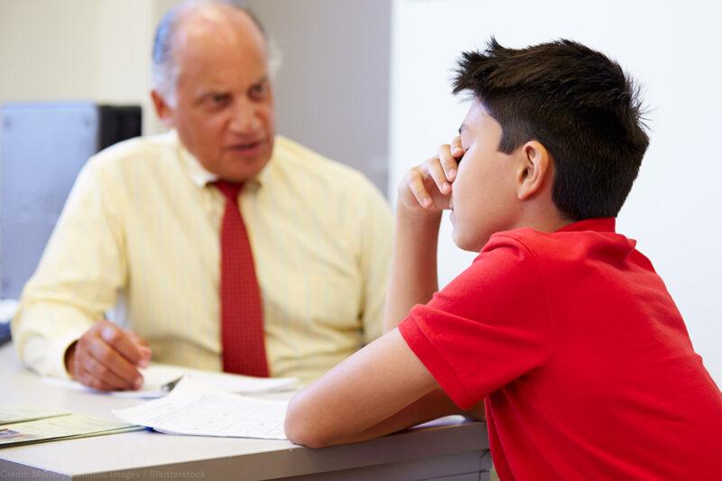 Distressed student sitting with a counselor