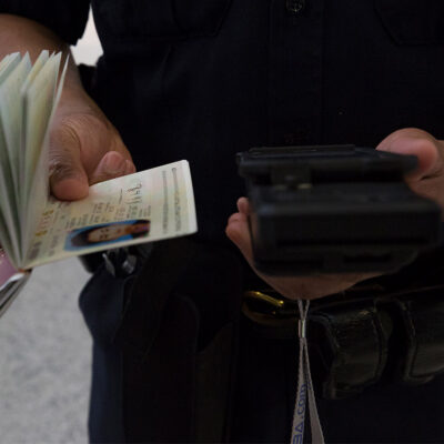 A CBP officer scanning a passport