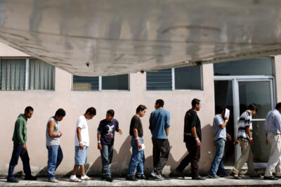 A line of Guatemalans arriving outside of the Guatemala City airport after having been deported from the US back to Guatemala.