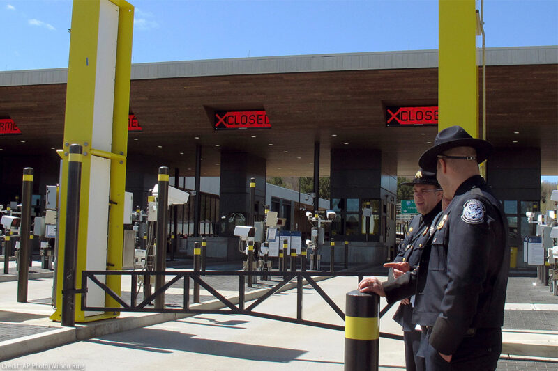 U.S. Customs and Border Protection officials stand at a border crossing facility on the U.S.-Canadian border