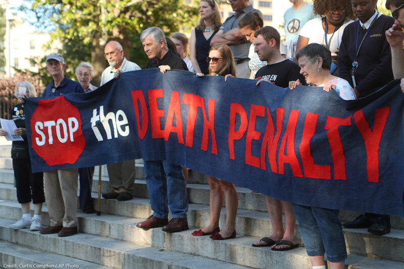 Protestors holding a banner that reads 