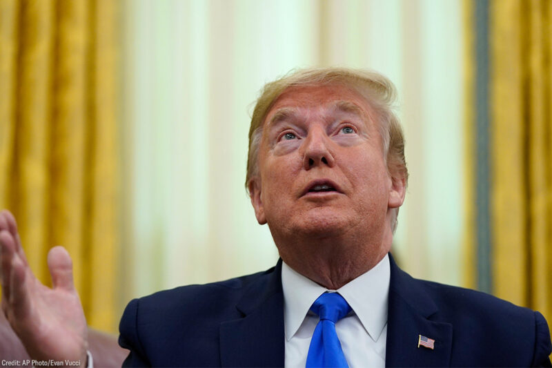 Donald Trump looking upward while speaking in the Oval Office.