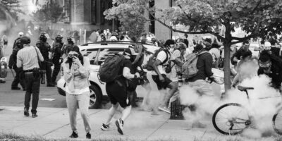 Black Lives Matter Protestors run as tear gas is dispensed into the crowd.