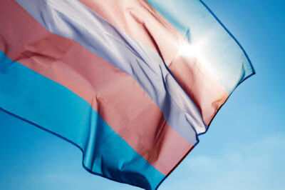 Trans pride flag on blue sky