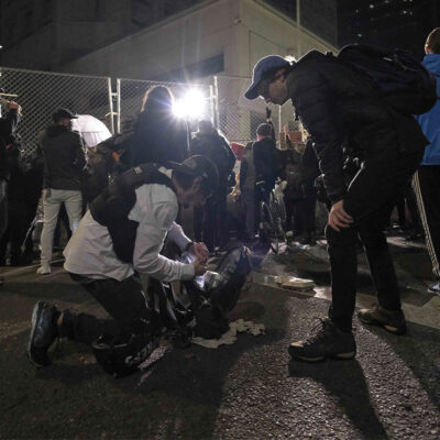 Two journalists prepare for police use of force.