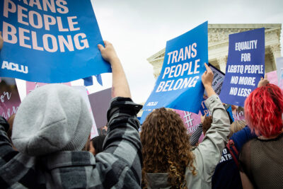 Demonstrators outside the Supreme Court with signs advocating for the rights of LGBTQ people.