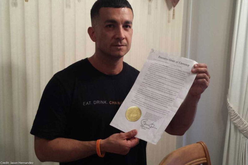 Jason Hernandez holding his executive grant of clemency given by President Barack Obama.